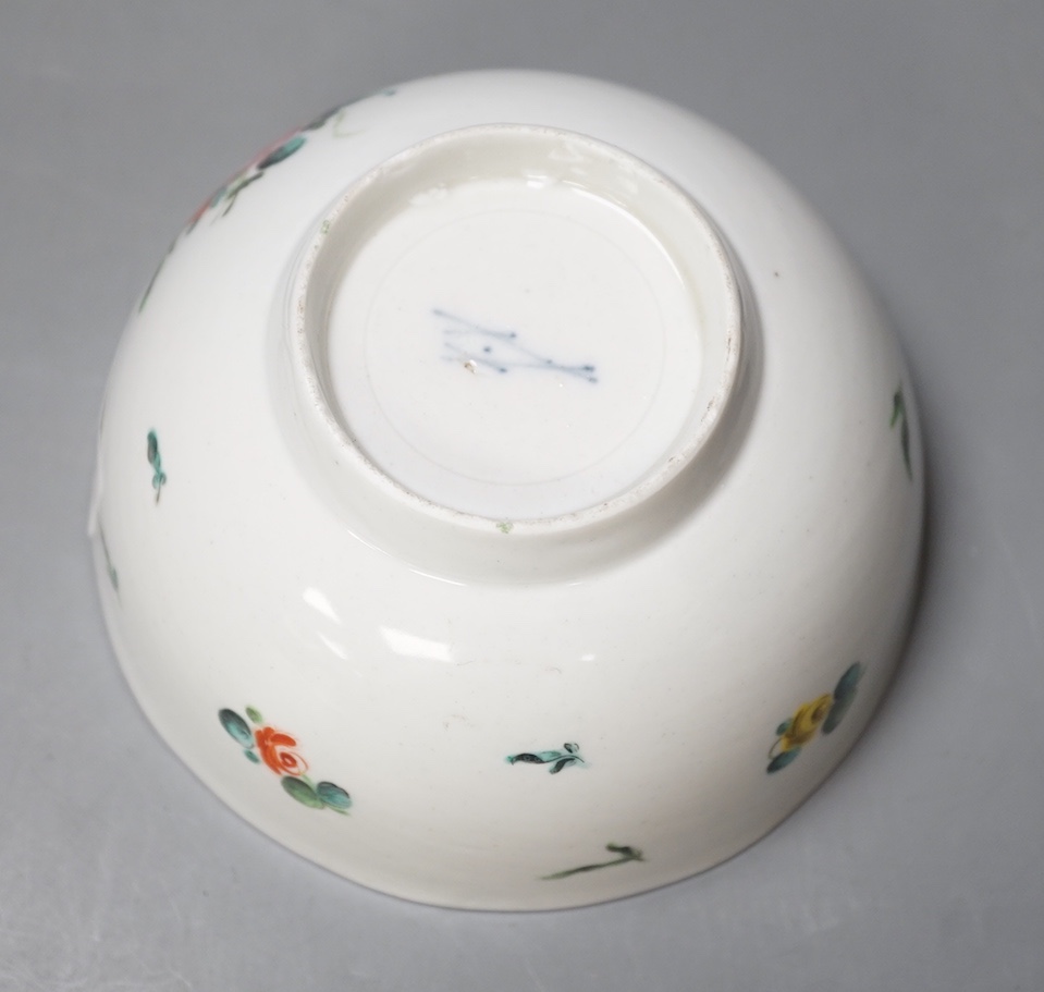 A Bristol porcelain bowl painted with a spray of flowers and scattered sprigs, crossed swords dot mark in under-glaze blue c.1775